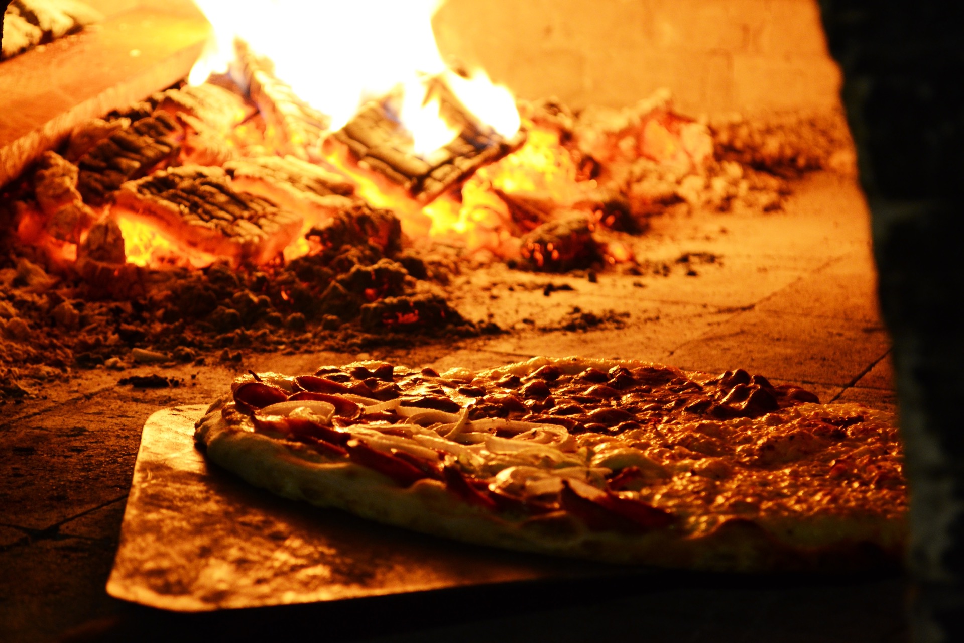 Pizza cooking in the wood fired oven